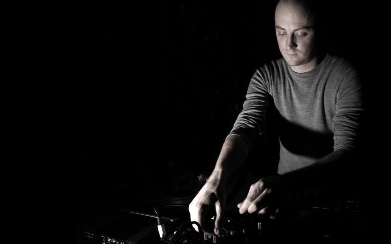 Black and white portrait of a man at the turntables