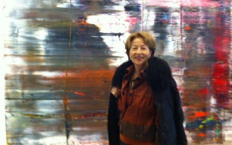 Portrait of a woman in front of a blurred picture