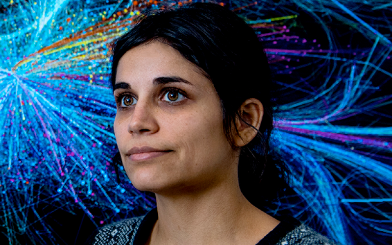 Portrait of Alice Grishchenko in front of a BarabásiLab artwork