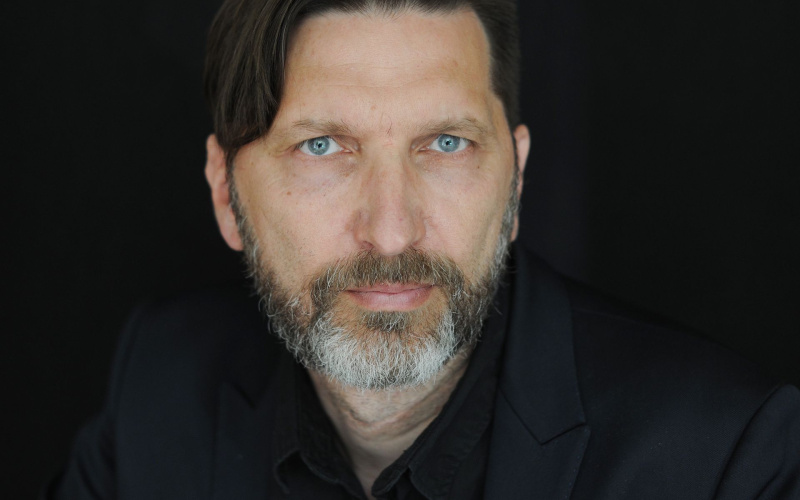Portrait of a bearded man against a black background
