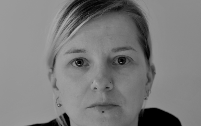 Black and white portrait of a woman in a dark sweater