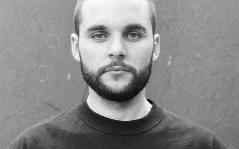 Black and white portrait of a man with a beard and short hair.