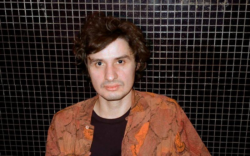 Portrait of a person in front of a black background.