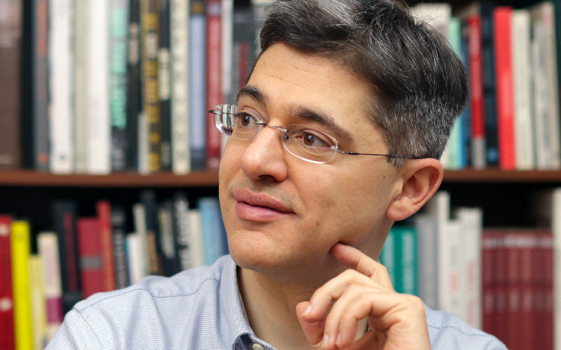 Portrait of a man wearing glasses in the library.