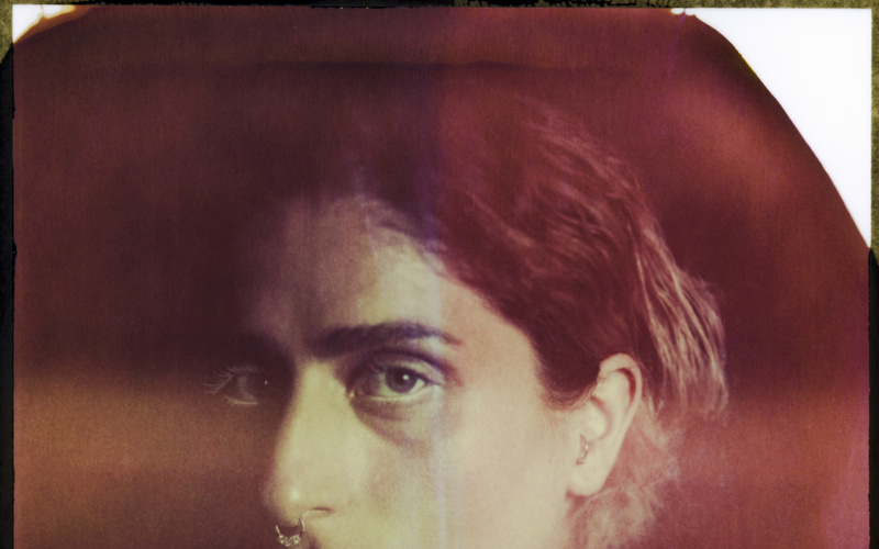 Brown-tinted analog photograph of a person. 