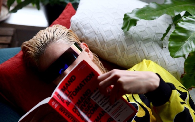 The photo shows a portrait of a person reading a book.
