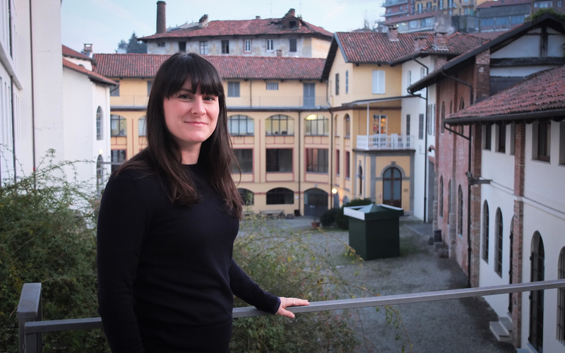 A woman in front of a house.