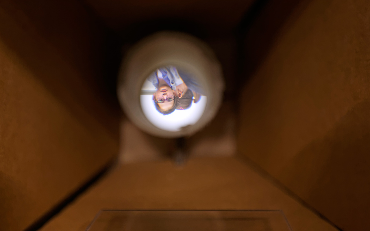 View through a cardboard tube on a girls face