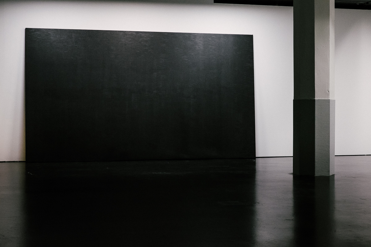 A black screen is placed in the room