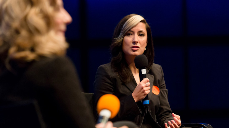 Woman speaking into a microphone