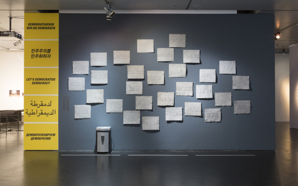 Eine Wand mit mehreren geprägten Papieren