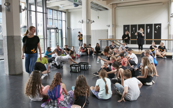 A group of teenagers sitting on the floor of the music balcony of the ZKM.