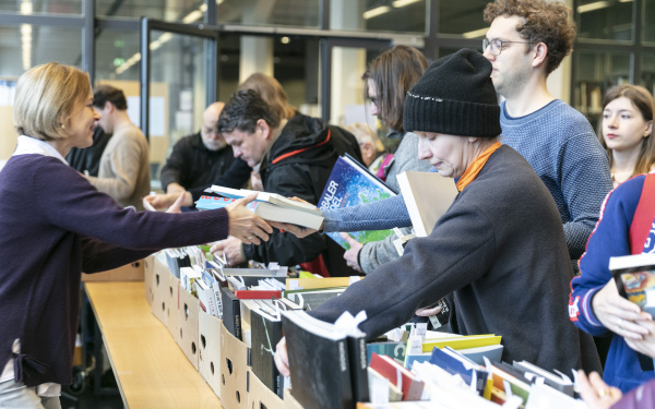 Many people at a book flea market.