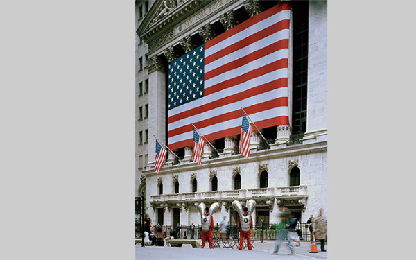 Two man in futuristic suits are standing in front of the New York' bourse