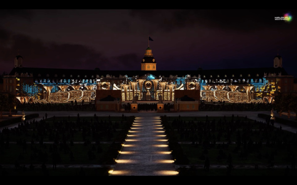 Auf der Karlsruher Schlossfassade ist ein Projection Mapping zu sehen, das in der Nacht leuchtet. 
