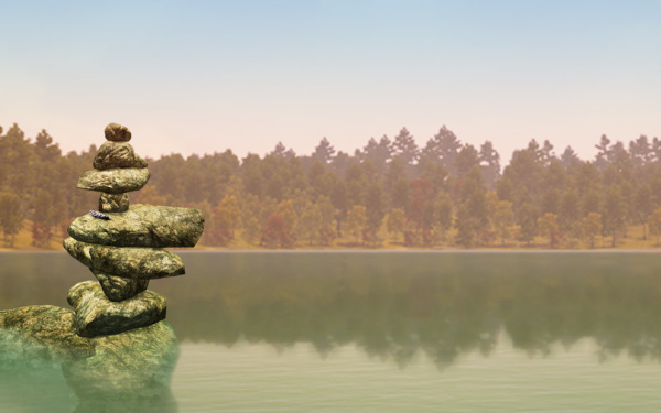 Das Bild zeigt einen Ausschnitt aus dem Videospiel "Walden a Game". Zu sehen ist ein weiter See, an dessen Rand Bäume stehen. Links sind Steine aufgetürmt zu einer meditativen Skulptur.