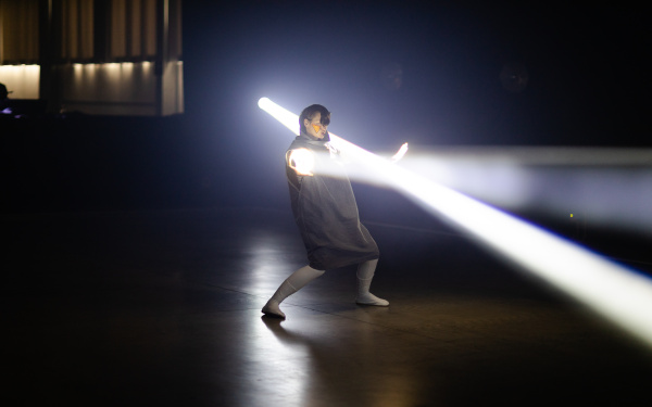 You can see a person illuminated by several spotlights