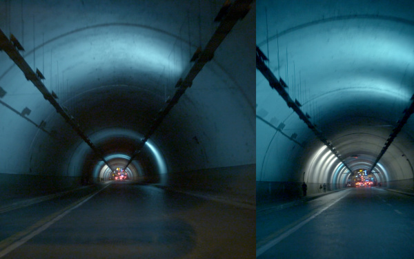 Man sieht zwei Tunnel. Am Ende des Tunnels sind rote Lichter zu sehen. Das Bild ist blau, schwarz.