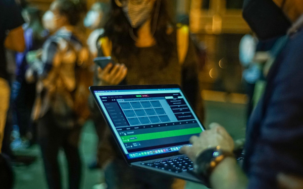 You can see a person holding a laptop in his hand.
