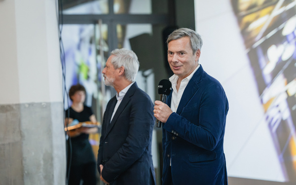 The picture shows two people giving a speech. 