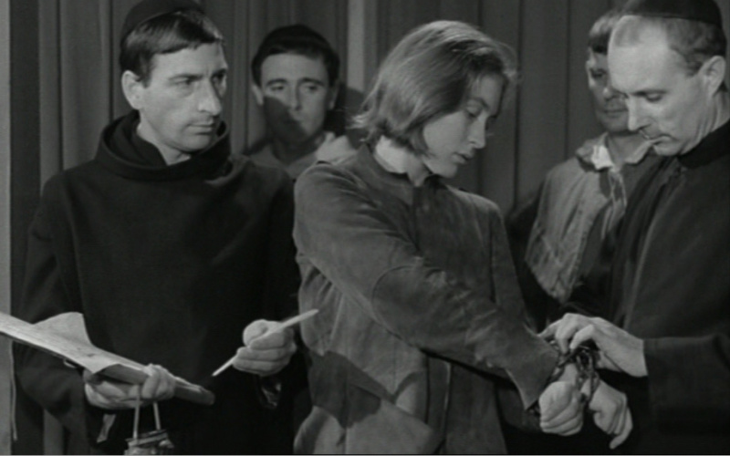 A man puts a woman in handcuffs.