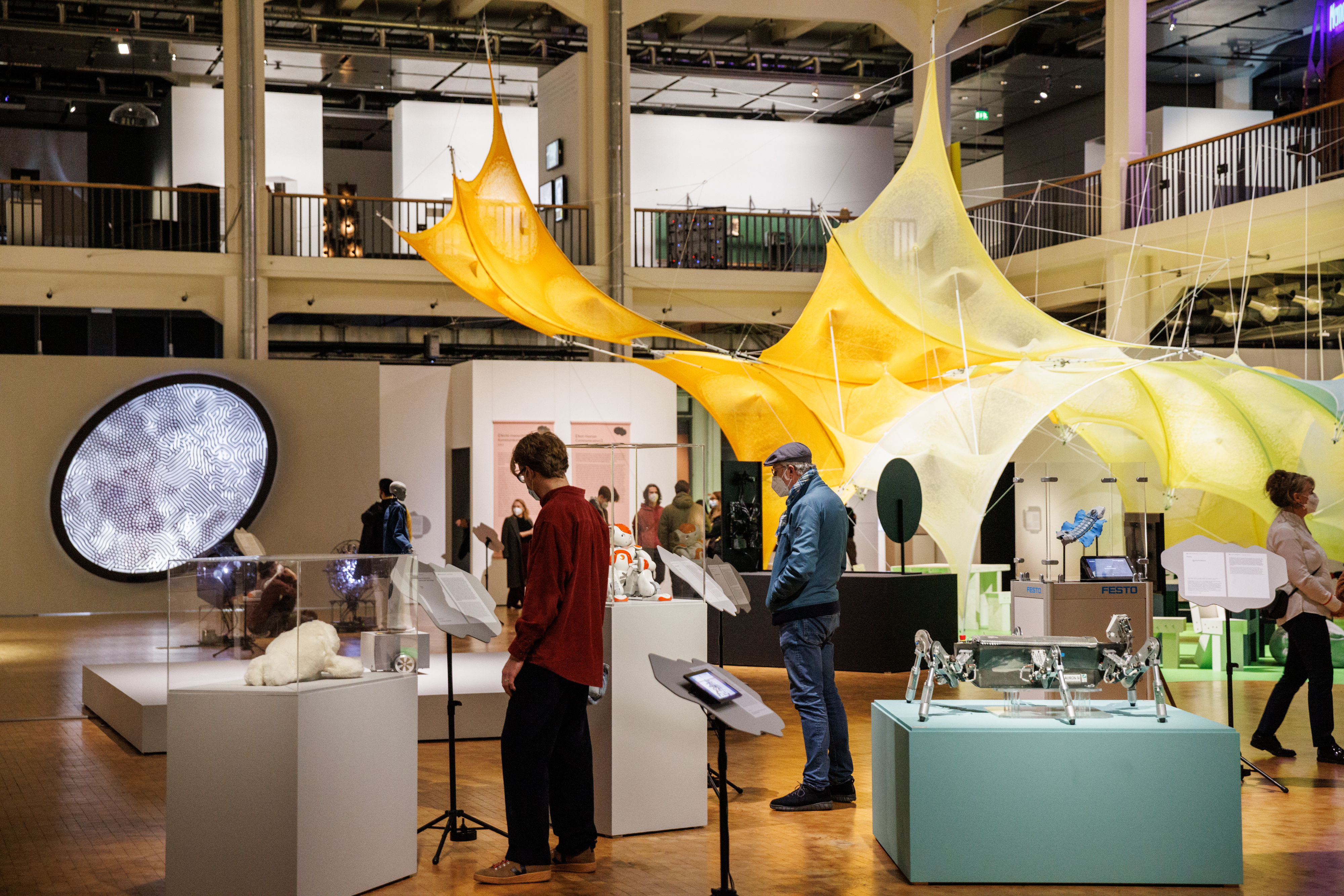 People look at exhibits of an exhibition