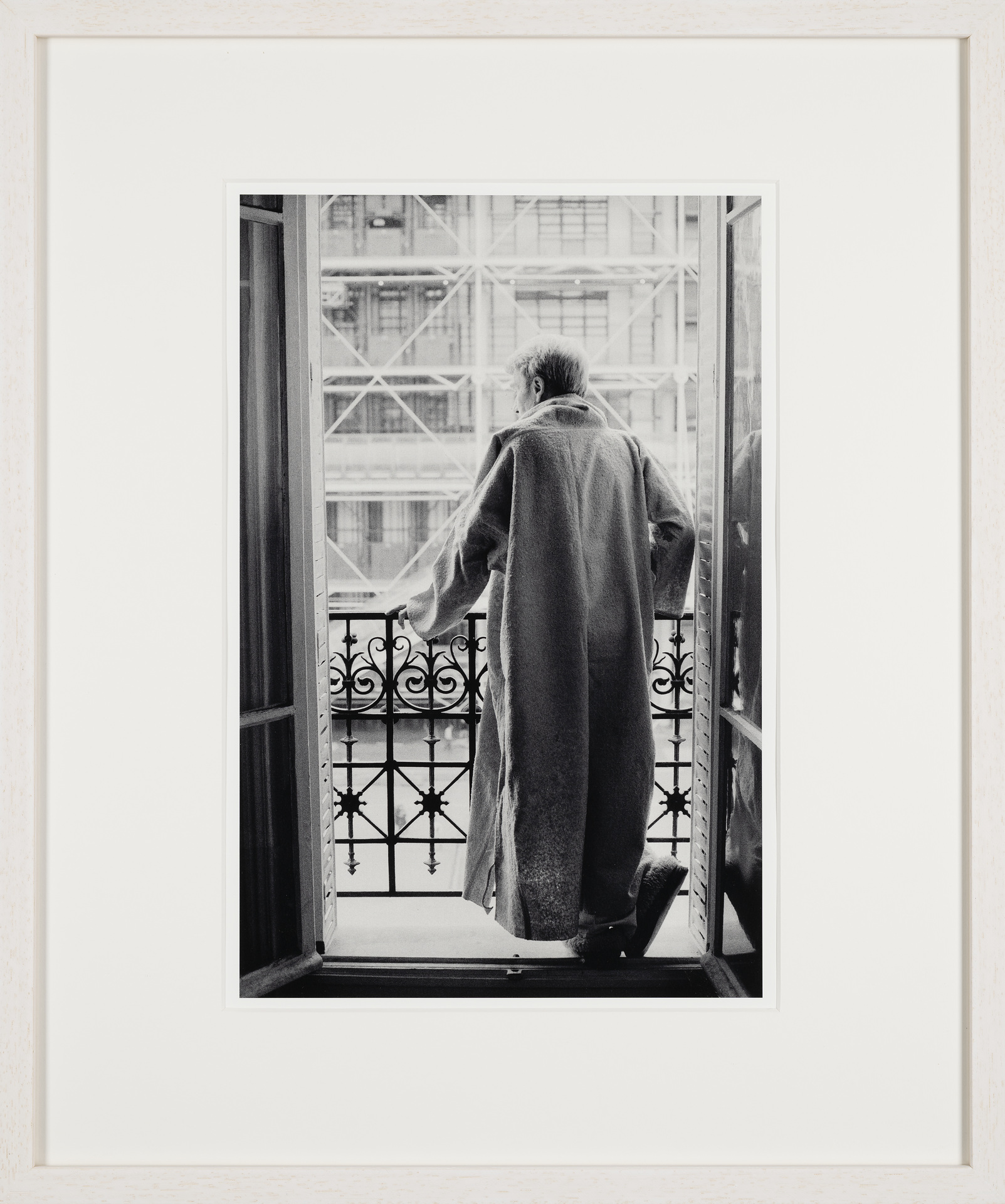 Brion posing for a series of photographs in his djellabah, standing in his window facing Centre Pompidou