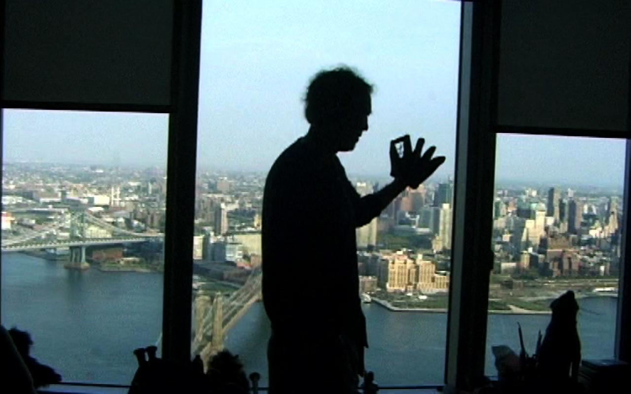 A skyline as a triptych in color. Before that, a man in profile view as a silhouette.