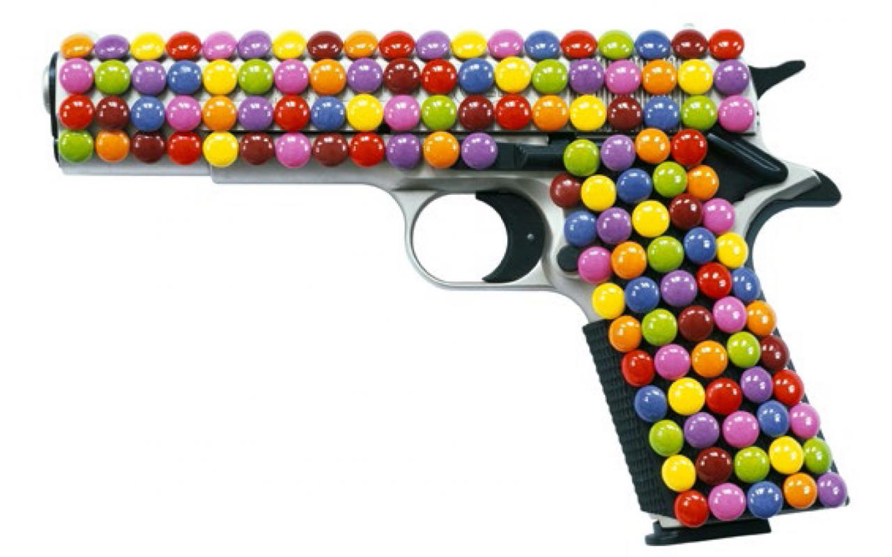 A gun is completely enveloped by Smarties.