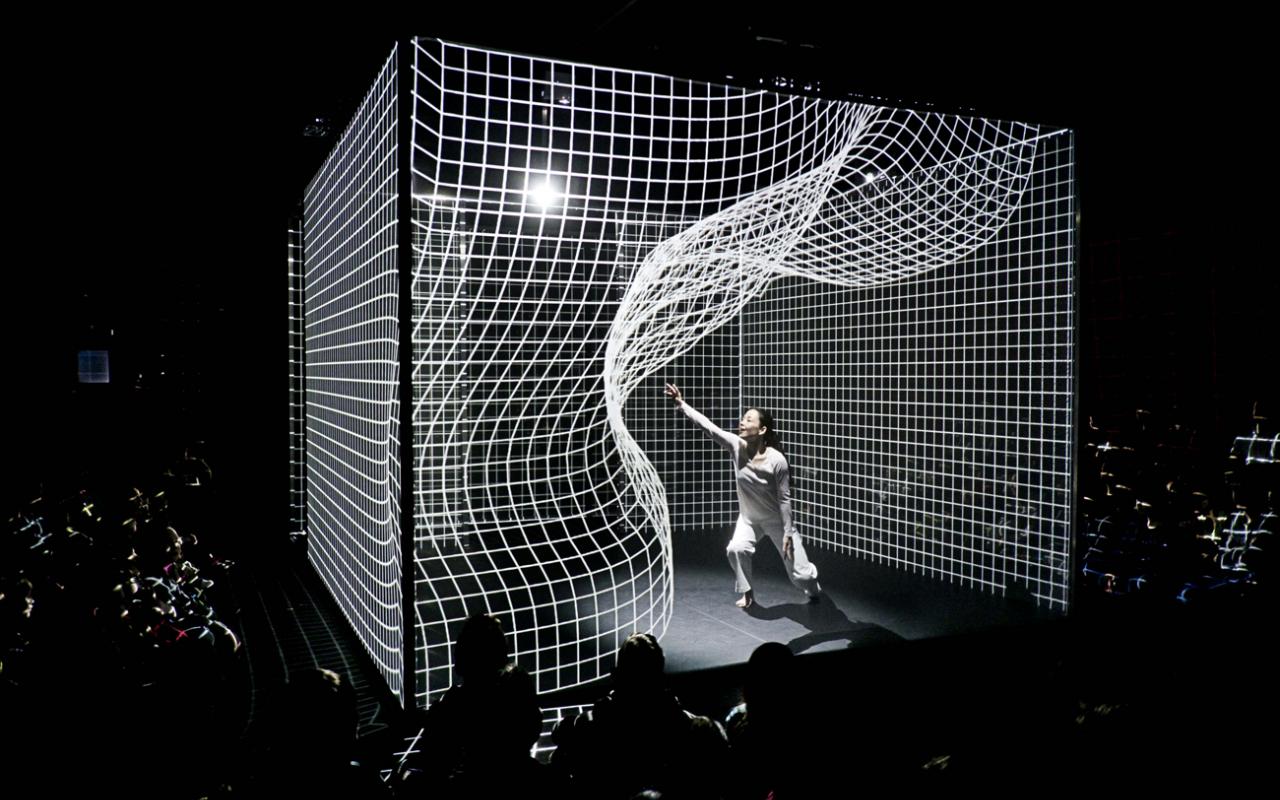 A person is dancing in the middle of an animated matrix