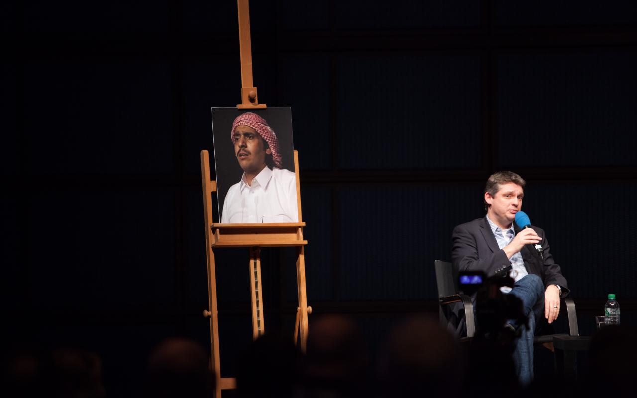 On an easel is a picture of a man with a turban