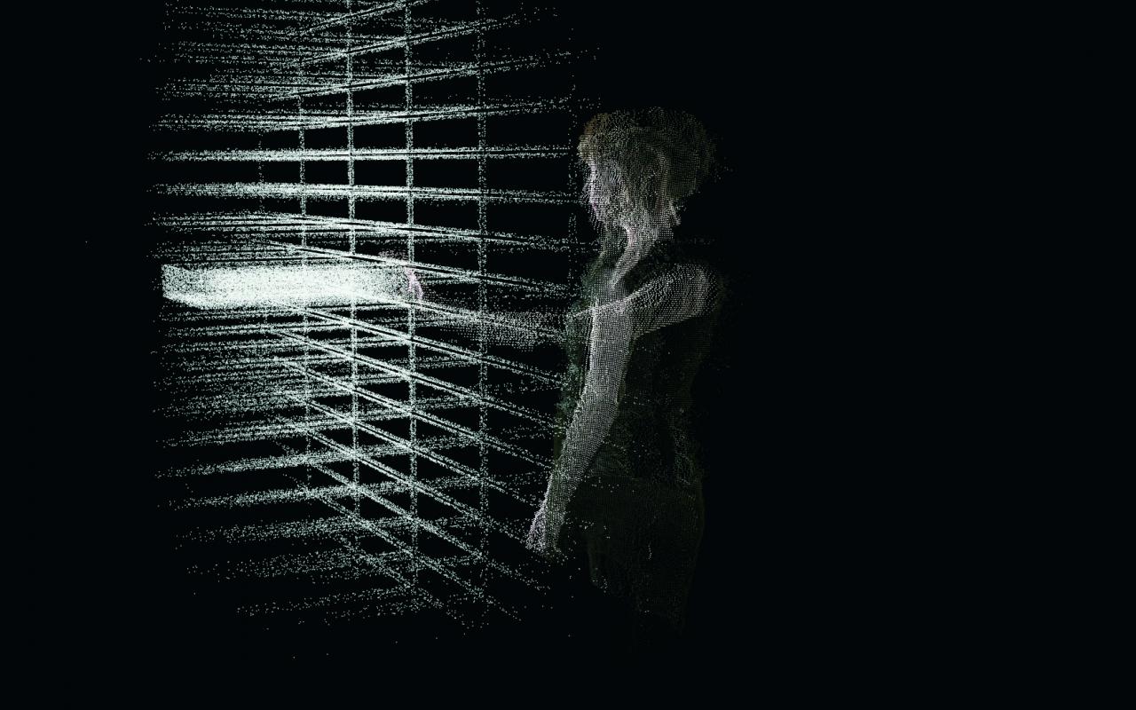  A silhouette of a woman from codes stands in front of a grid of codes.