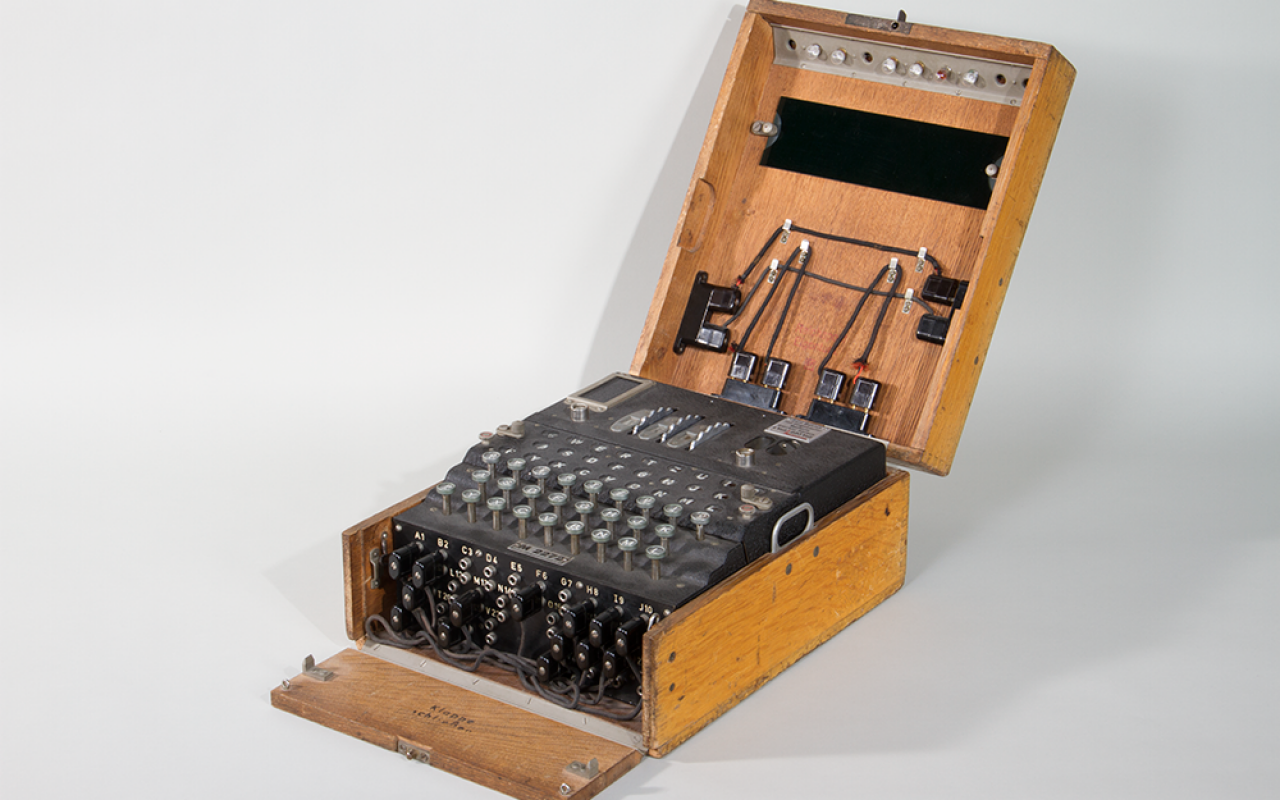 Black apparatus with buttons and cables in a wooden box