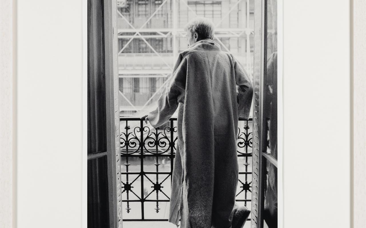 Werk - Brion posing for a series of photographs in his djellabah, standing in his window facing Centre Pompidou