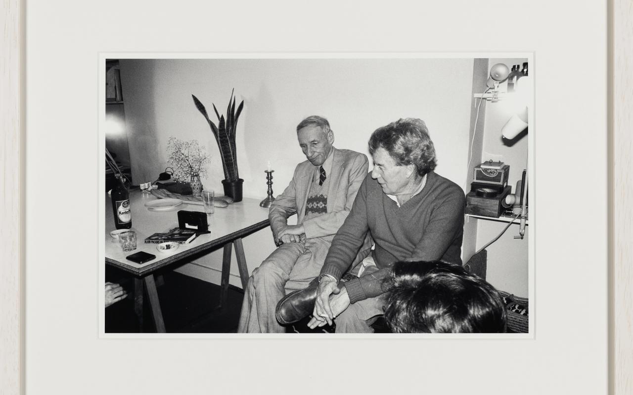 Enjoying a visit by William Burroughs. The two best friends sitting on Brion’s Tanger chest, holding important documents of the two. The shock of hair in the foreground could be Terry Wilson’s who often came over from London whenever WSB was visiting