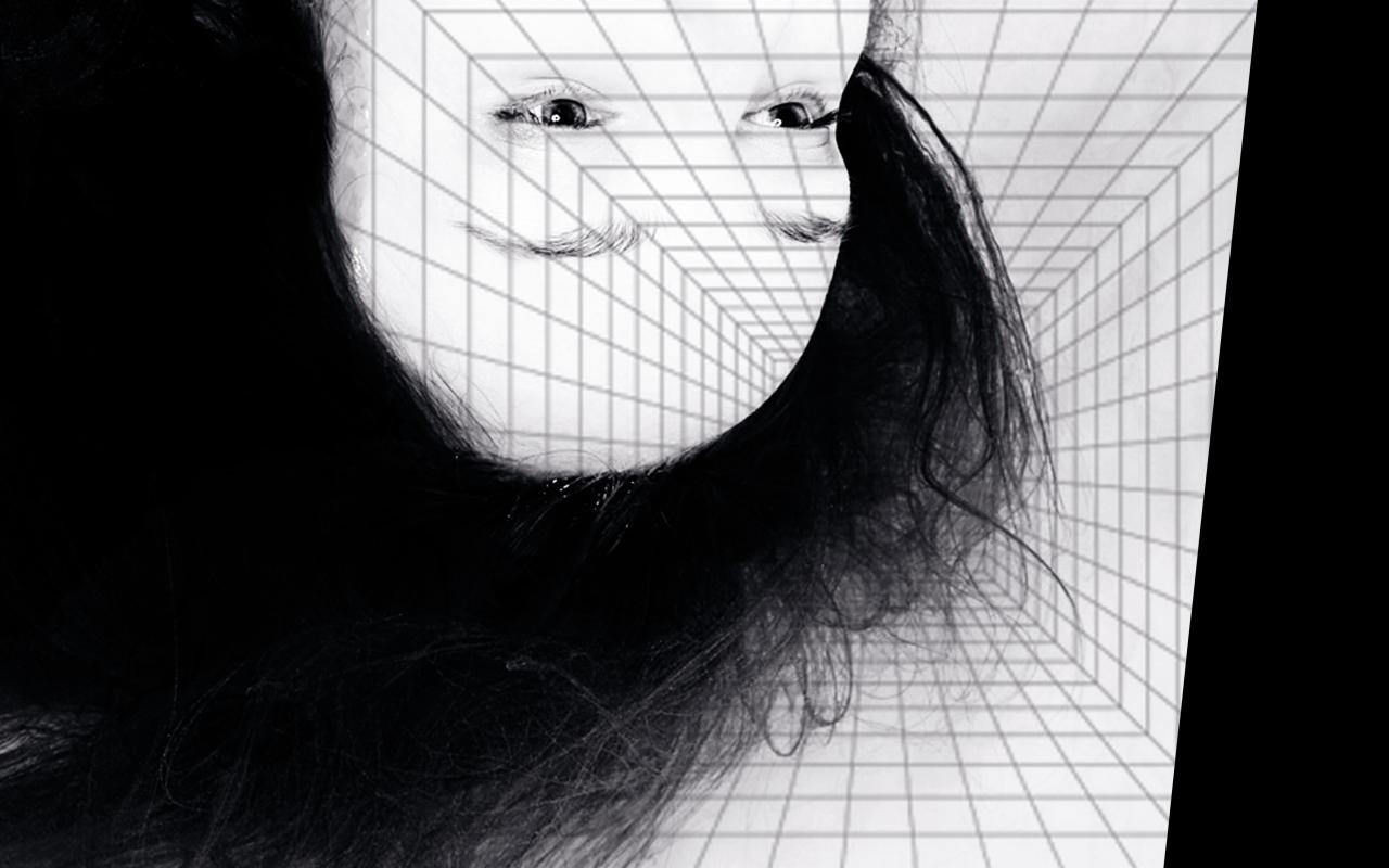 The head and neck of a woman can be seen upside down, she has long hair and an expressionless lead. The background resembles computer-generated tiles, which also cover her face.