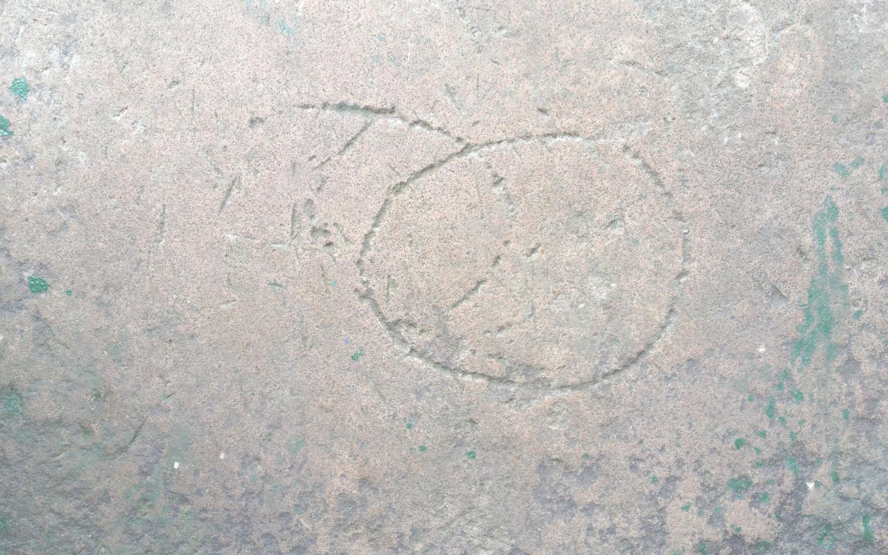 Circular shapes carved on a stone surface.