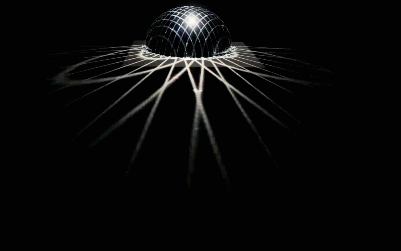  An illuminated black ball throws rays into a dark room
