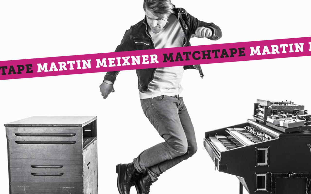 The photo shows Martin Meixner jumping next to his keyboard
