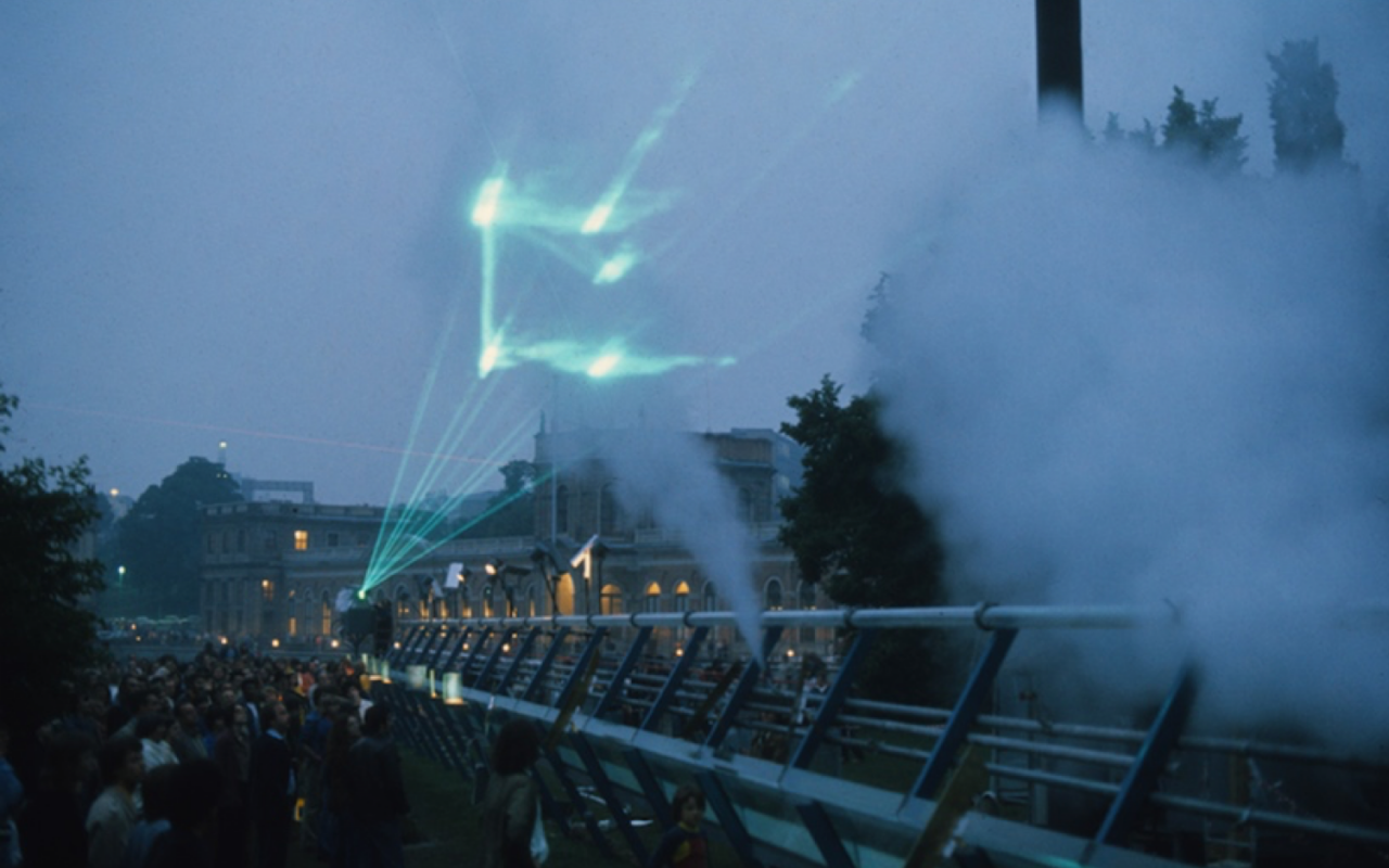  The picture shows a green laser show with audience