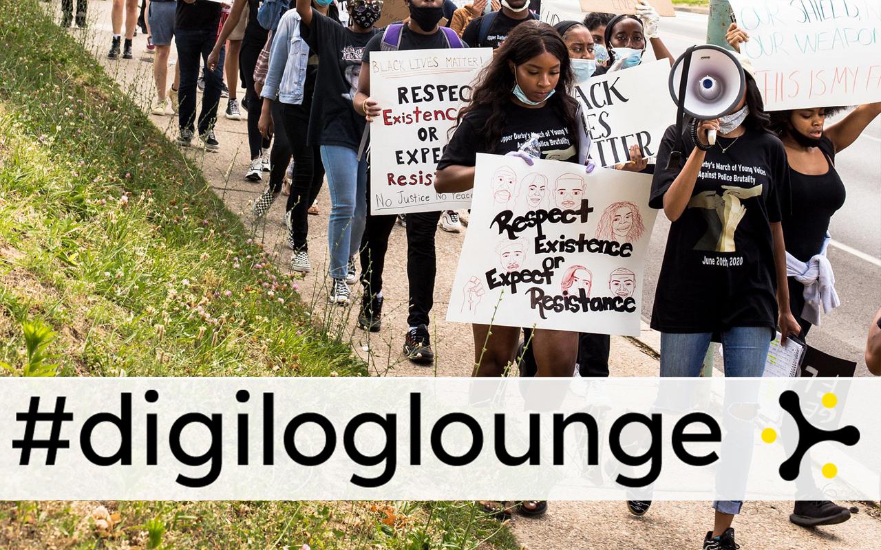 You can see a demonstration with people holding signs. Big above the picture is #digiloglounge