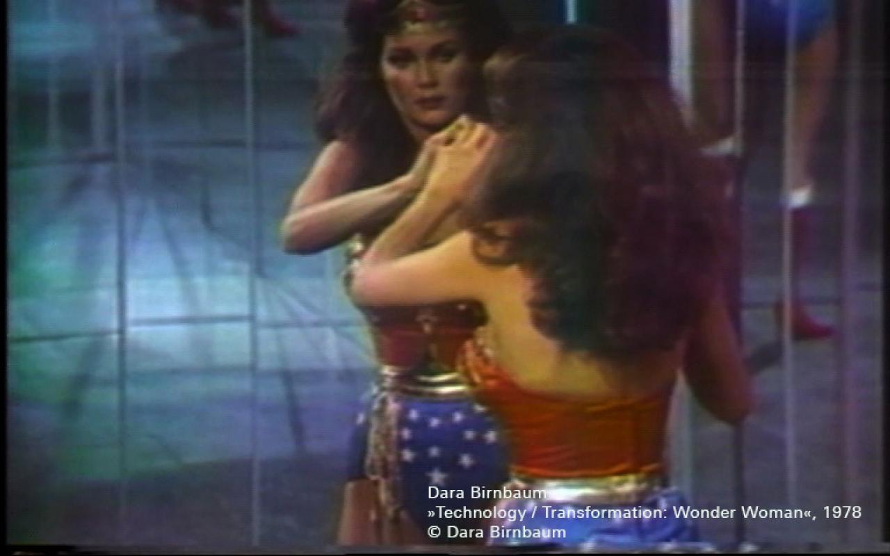 Wonderwoman looks at herself in the mirror