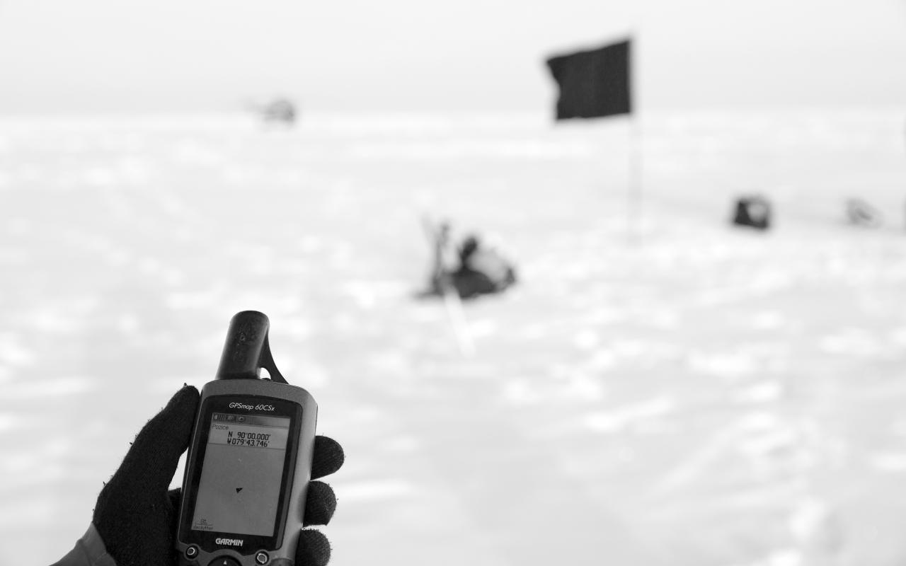 The picture shows a black flag at the North Pole in black and white.