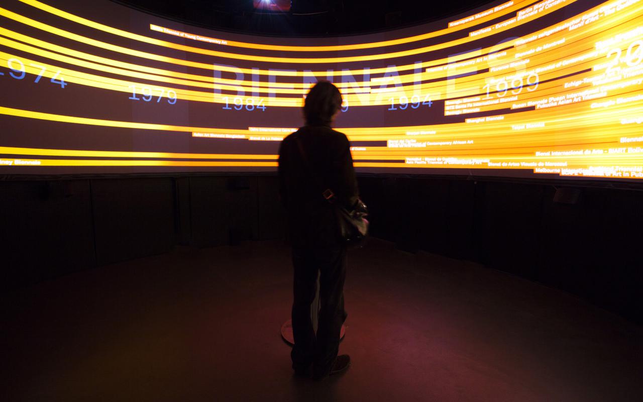 A man standing in front of a 360° view of yellow lightnings