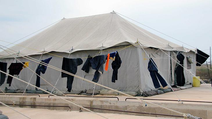 Laundry on a clothesline in front of a tent
