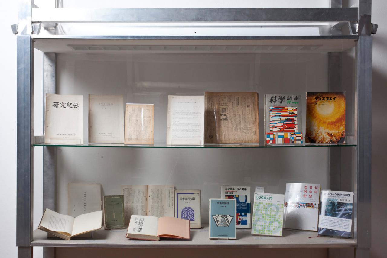 View into a display case with publications by Hiroshi Kawano.