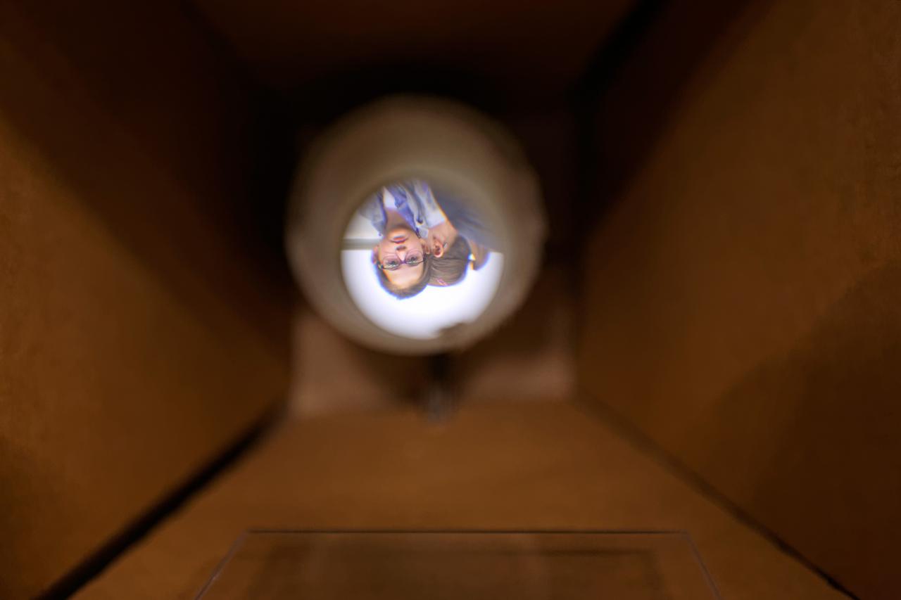 View through a cardboard tube on a girls face