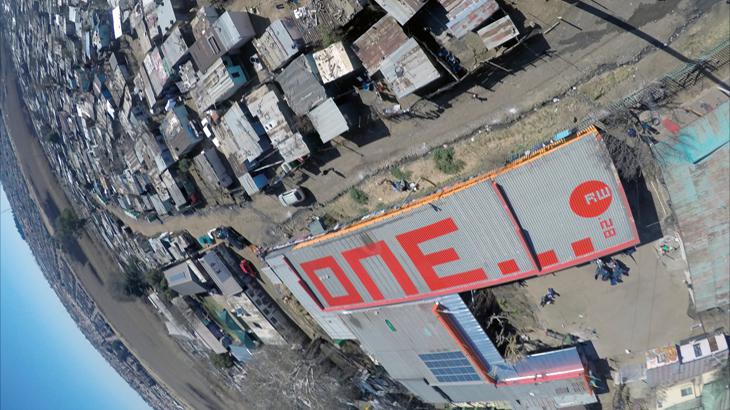 The word "one" in red letters on a roof