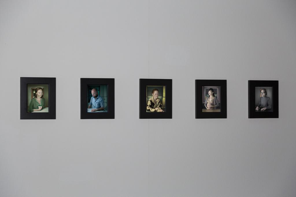 Five individually framed portraits of different persons.