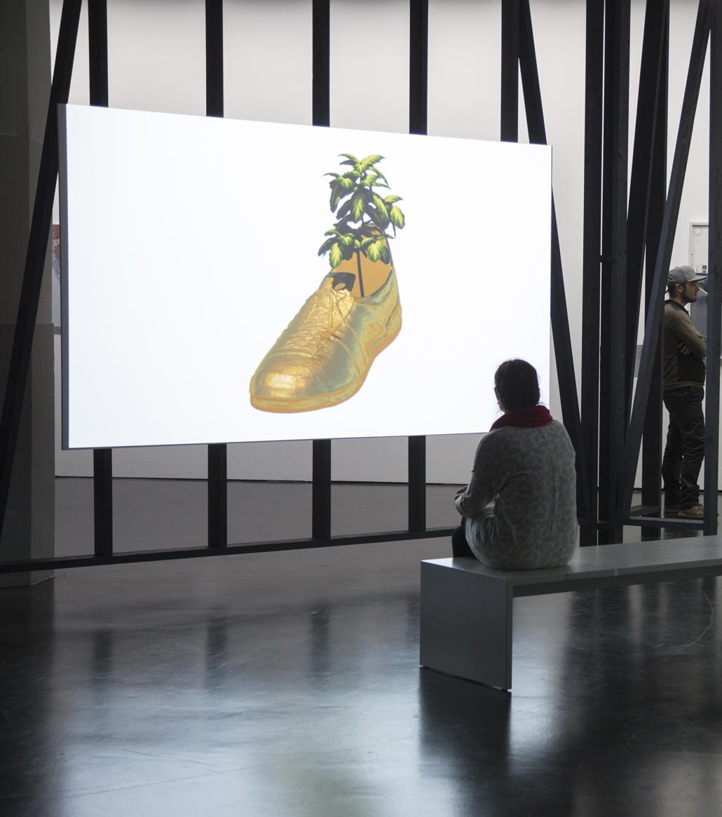 Ein gemalter goldener Schuh, aus dem eine Palme wächst